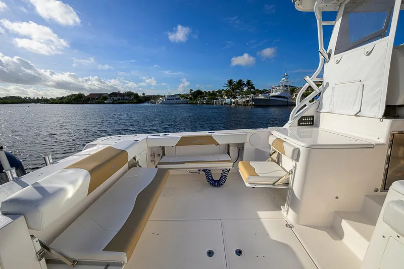  Yacht Photos Pics 2016 Edgewater 335 Express boat interior with seating, overlooking a scenic waterfront.