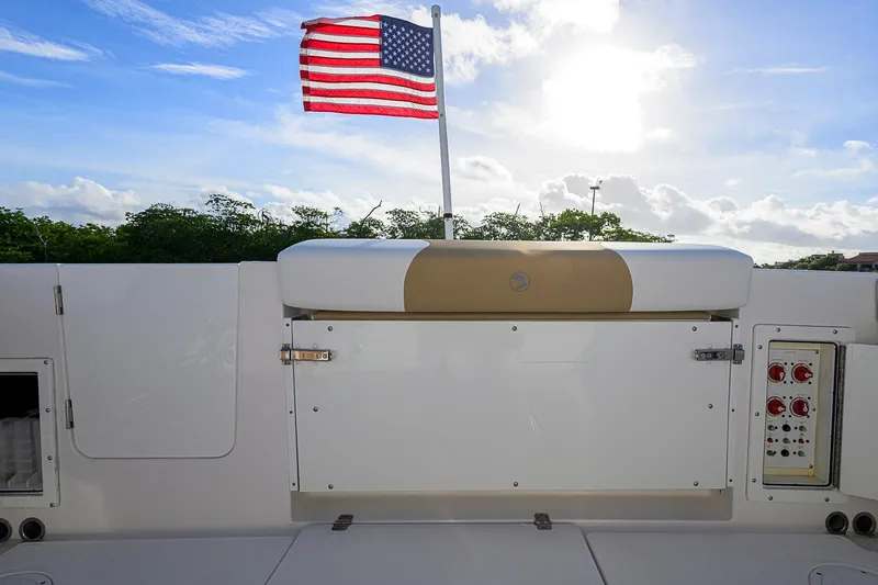  Yacht Photos Pics 2016 Edgewater 335 Express boat with American flag, sunny sky, and control panel.