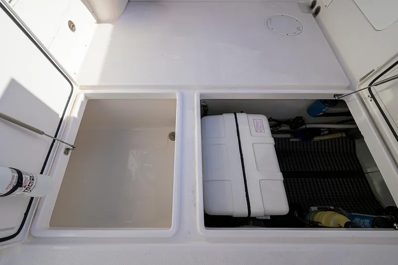  Yacht Photos Pics 2016 Edgewater 335 Express boat storage compartments with equipment and fire extinguisher.