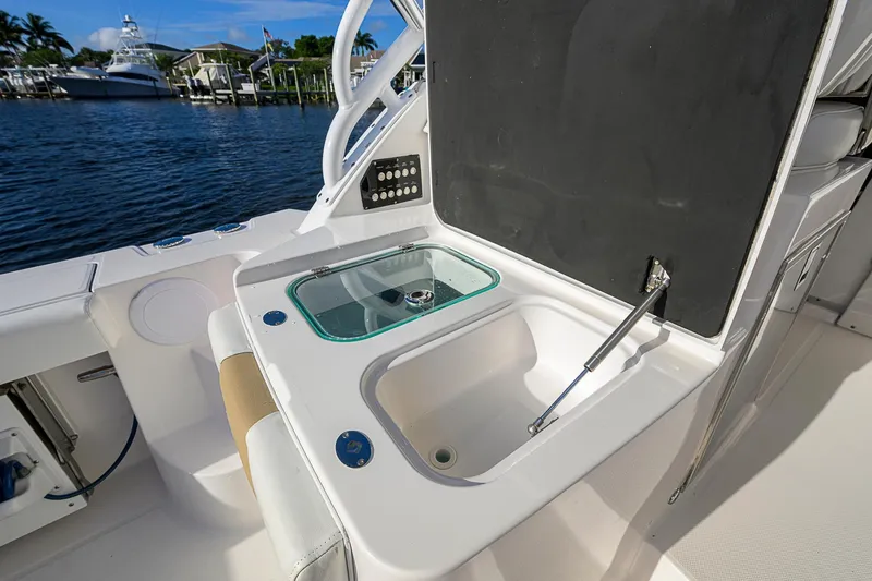  Yacht Photos Pics 2016 Edgewater 335 Express boat interior with sink and storage, docked by the water.