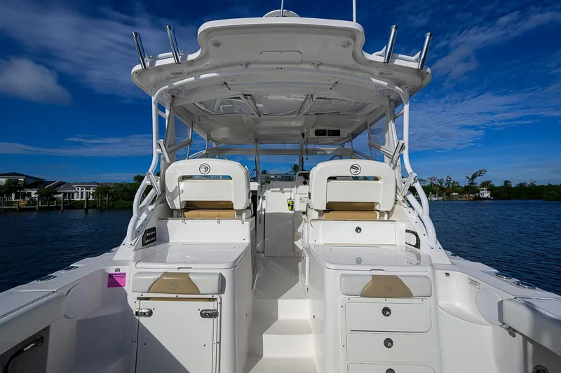  Yacht Photos Pics 2016 Edgewater 335 Express boat interior with seating and storage, under a clear blue sky.