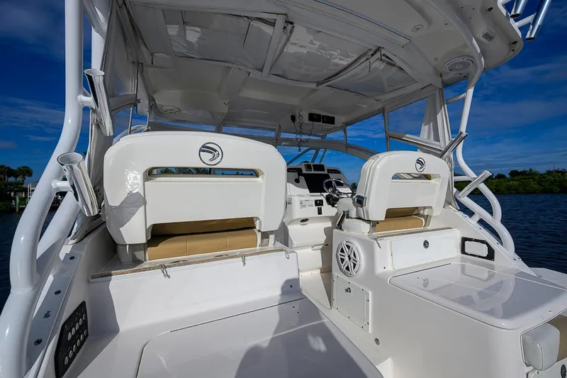  Yacht Photos Pics 2016 Edgewater 335 Express boat interior with helm and seating, under clear blue sky.