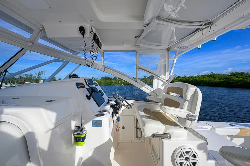  Yacht Photos Pics 2016 Edgewater 335 Express boat interior with helm, seats, and water view.