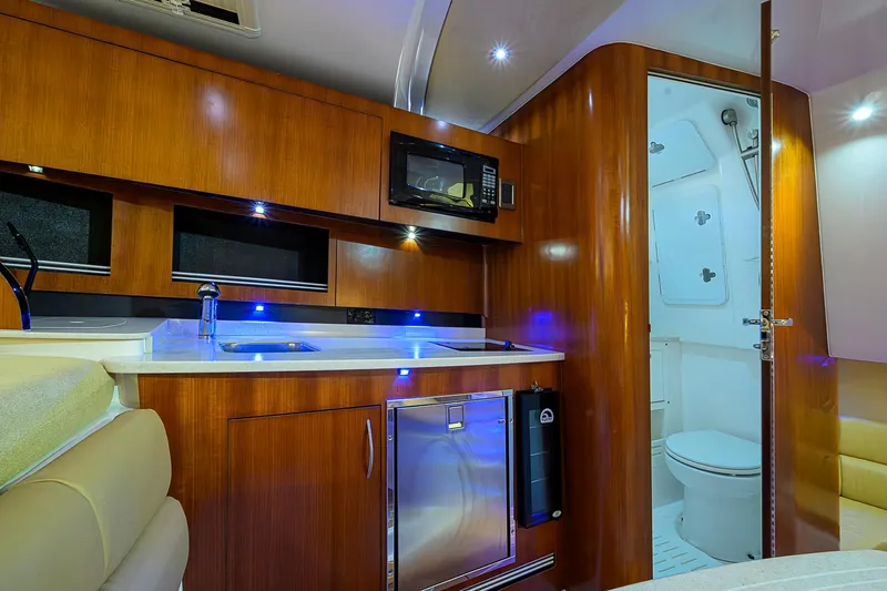  Yacht Photos Pics Luxurious interior of 2016 Edgewater 335 Express boat with kitchenette and bathroom.