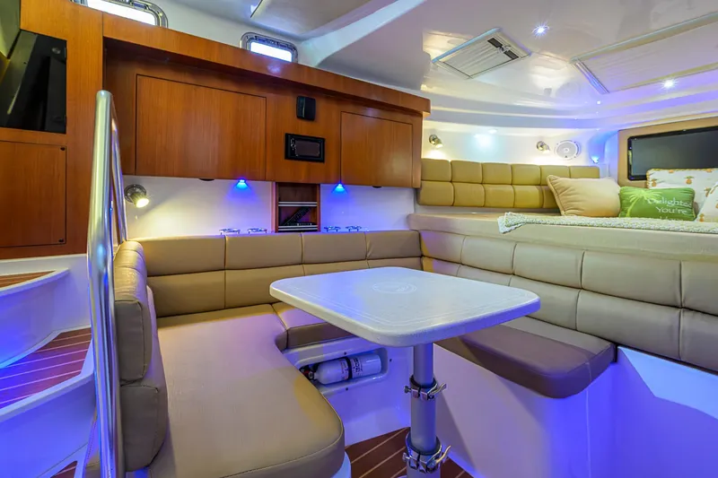  Yacht Photos Pics Luxurious interior of 2016 Edgewater 335 Express boat with cozy seating and ambient lighting.
