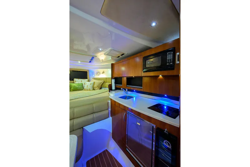  Yacht Photos Pics Luxurious interior of 2016 Edgewater 335 Express boat with modern kitchen amenities.
