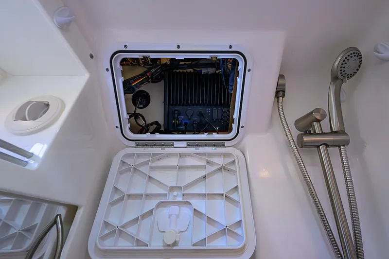  Yacht Photos Pics 2016 Edgewater 335 Express boat interior with shower and access panel.