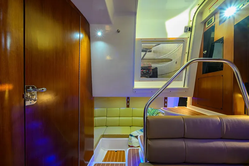  Yacht Photos Pics Luxurious interior of 2016 Edgewater 335 Express boat with wooden finishes and seating.