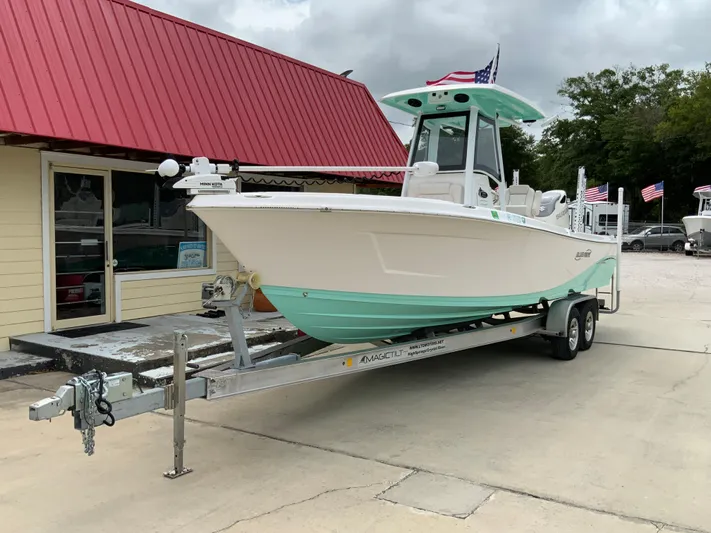  Yacht Photos Pics 2021 Blue Wave 2800 Makaira boat on a trailer outside a building with a red roof.