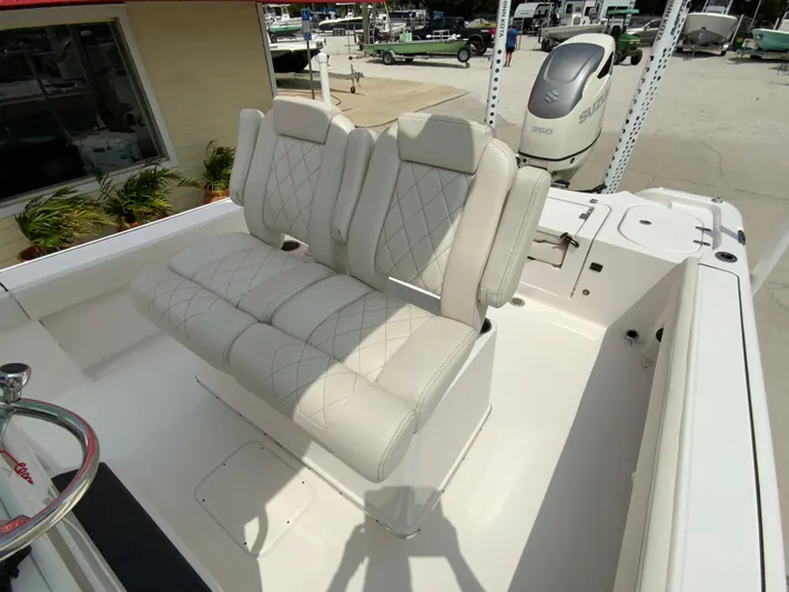  Yacht Photos Pics 2021 Blue Wave 2800 Makaira boat with cushioned seating and outboard motor.