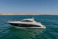 2005 Astondoa 53 Open yacht cruising on blue ocean near coastline.