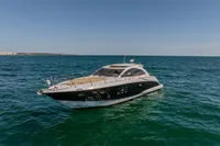 Astondoa 53 Open 2005 yacht cruising on open sea under clear blue sky.