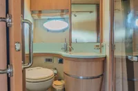 Luxurious bathroom in 2005 Astondoa 53 Open yacht with modern fixtures and wood accents.