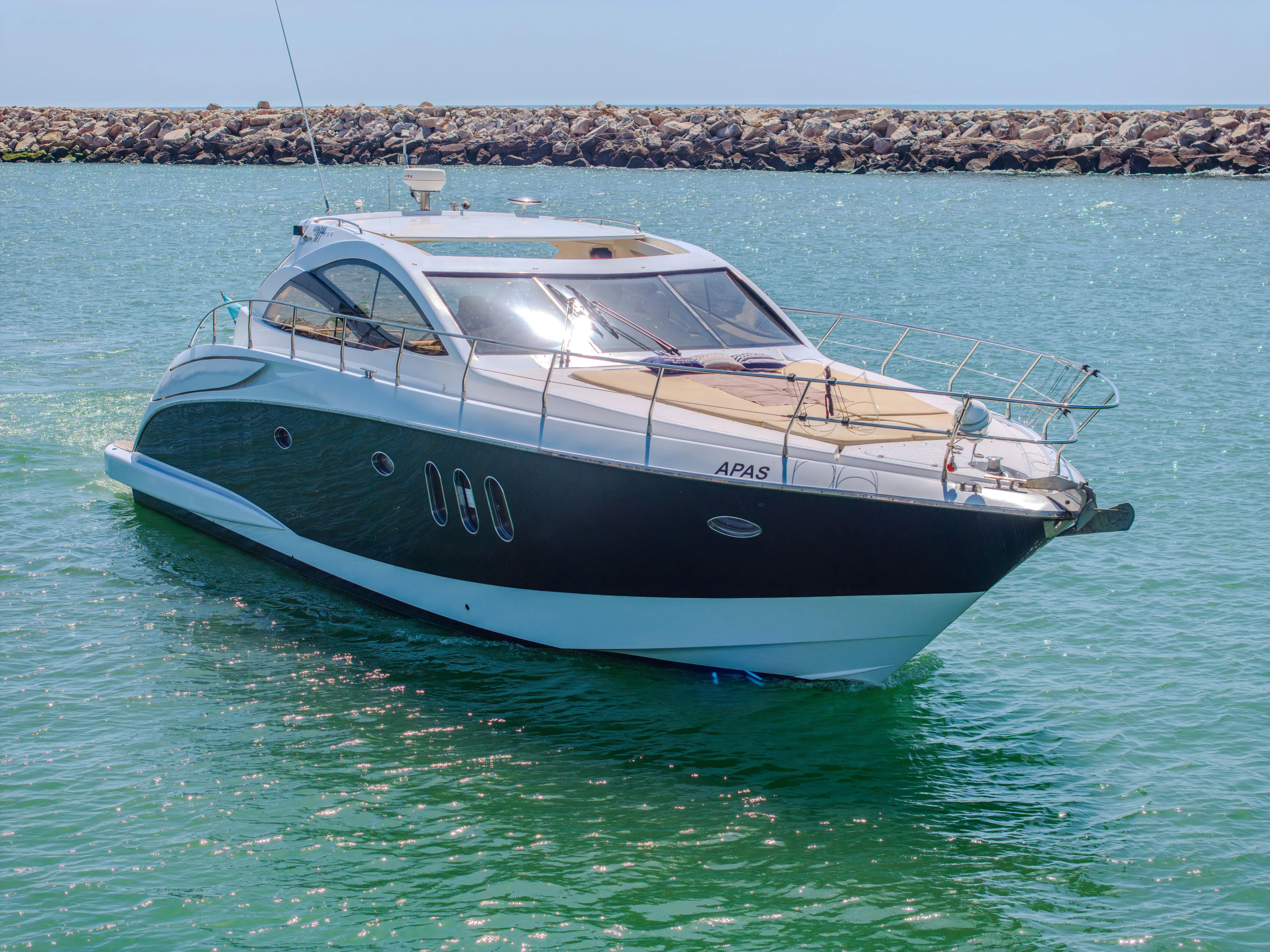 2005 Astondoa 53 Open yacht cruising on clear blue water.
