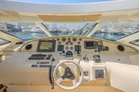 Control panel of 2005 Astondoa 53 Open yacht with navigation instruments and steering wheel.