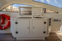 Outdoor kitchenette on 2005 Astondoa 53 Open yacht with sink and storage.