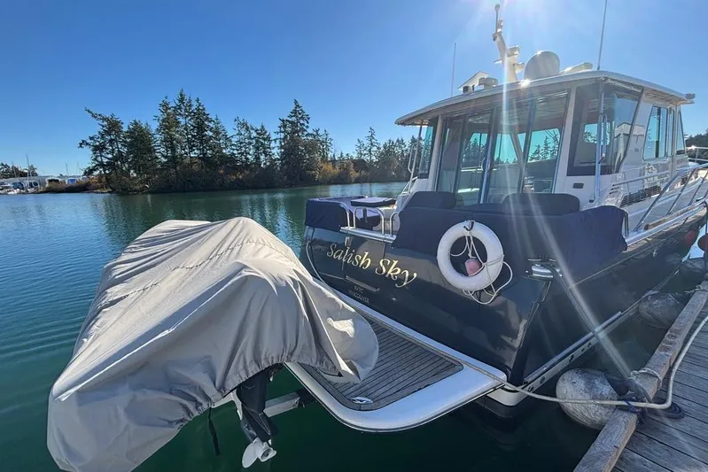 Salish Sky Yacht Photos Pics 2015 Sabre 54 Salon Express yacht docked, featuring covered equipment and lifebuoy.