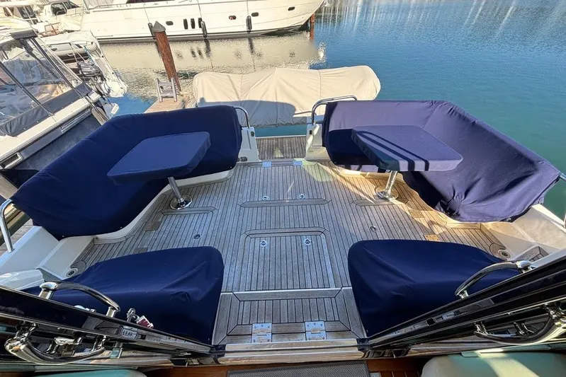 Salish Sky Yacht Photos Pics Spacious deck of 2015 Sabre 54 Salon Express with blue seating and tables.