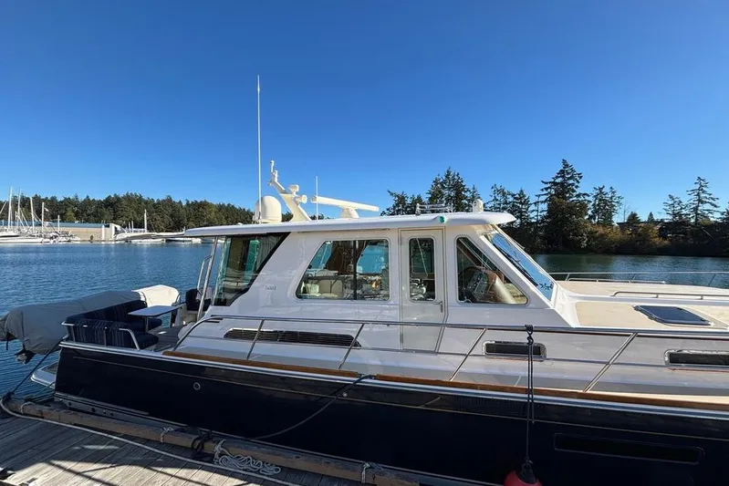 Salish Sky Yacht Photos Pics 2015 Sabre 54 Salon Express yacht docked by a serene waterfront.