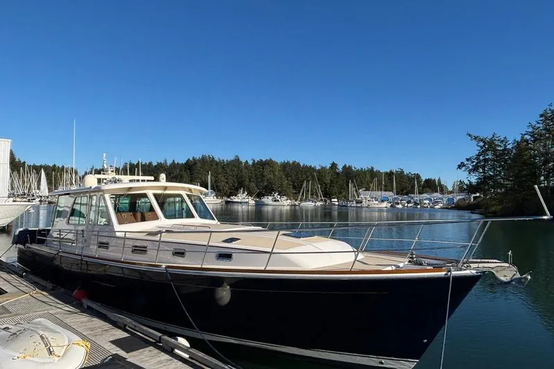 Salish Sky Yacht Photos Pics 2015 Sabre 54 Salon Express yacht docked in a serene marina setting.
