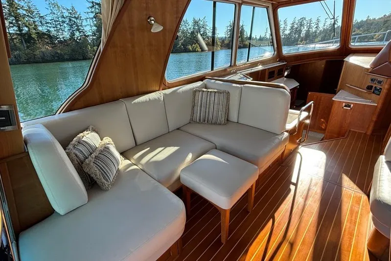 Salish Sky Yacht Photos Pics Luxurious interior of 2015 Sabre 54 Salon Express yacht with elegant seating and scenic views.