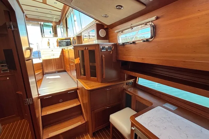 Salish Sky Yacht Photos Pics Luxurious interior of 2015 Sabre 54 Salon Express yacht with wooden cabinetry and seating.