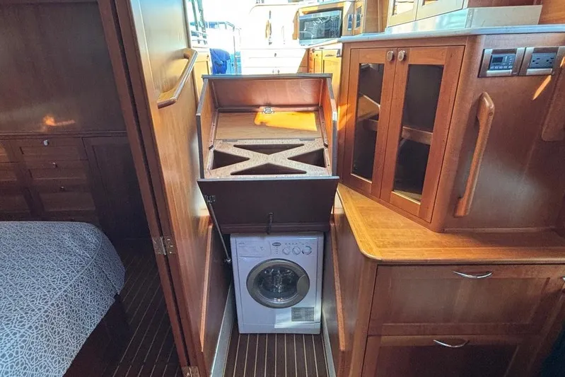 Salish Sky Yacht Photos Pics Laundry area in 2015 Sabre 54 Salon Express yacht with wooden cabinetry.