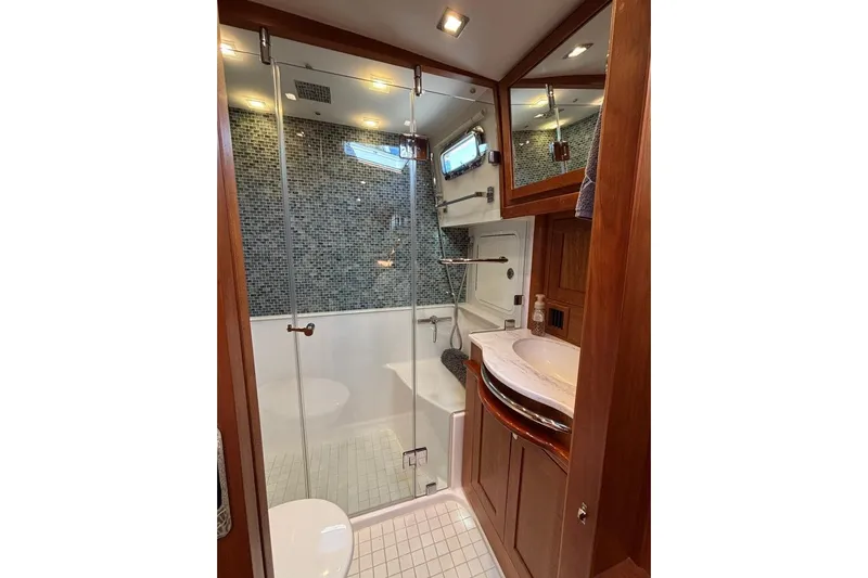 Salish Sky Yacht Photos Pics Luxurious bathroom in 2015 Sabre 54 Salon Express yacht with glass shower and wood accents.