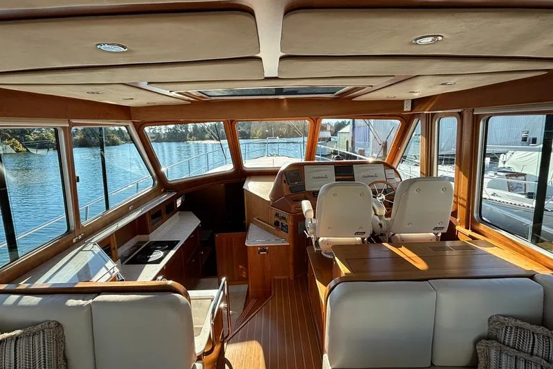Salish Sky Yacht Photos Pics Interior of 2015 Sabre 54 Salon Express yacht with helm and seating area.