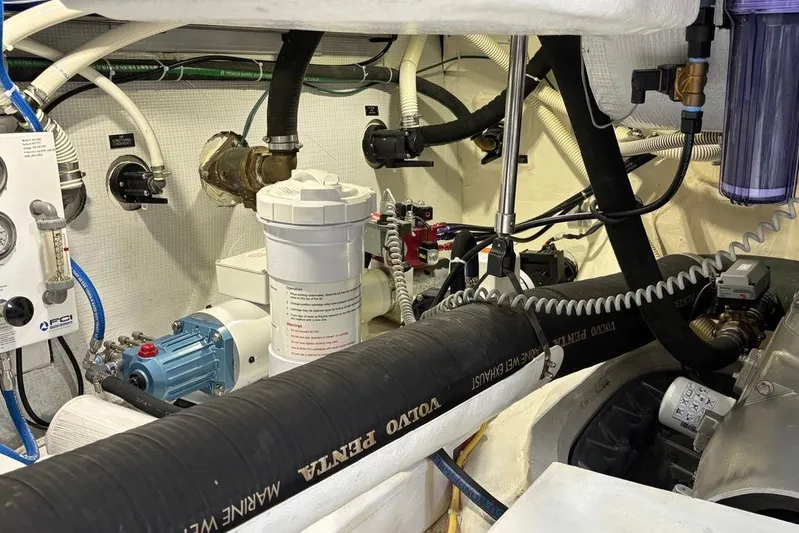 Salish Sky Yacht Photos Pics Engine room of 2015 Sabre 54 Salon Express with various mechanical components and hoses.