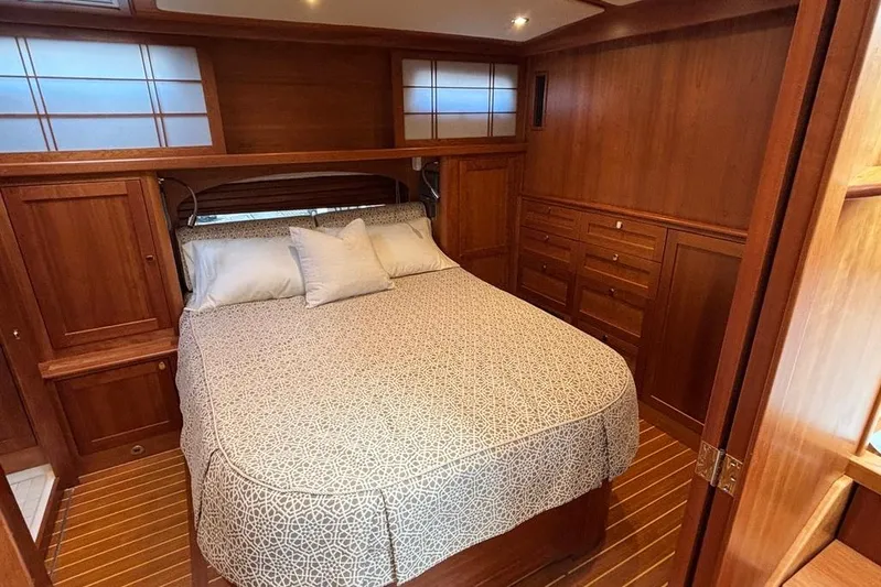Salish Sky Yacht Photos Pics Luxurious wood-finished bedroom in 2015 Sabre 54 Salon Express yacht.