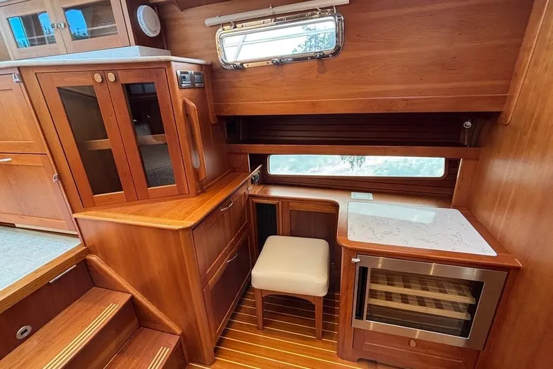 Salish Sky Yacht Photos Pics 2015 Sabre 54 Salon Express interior with wooden cabinetry and seating area.