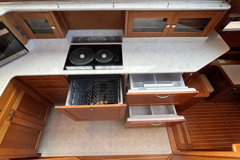 Salish Sky Yacht Photos Pics 2015 Sabre 54 Salon Express kitchen with stove, dishwasher, and wooden cabinetry.