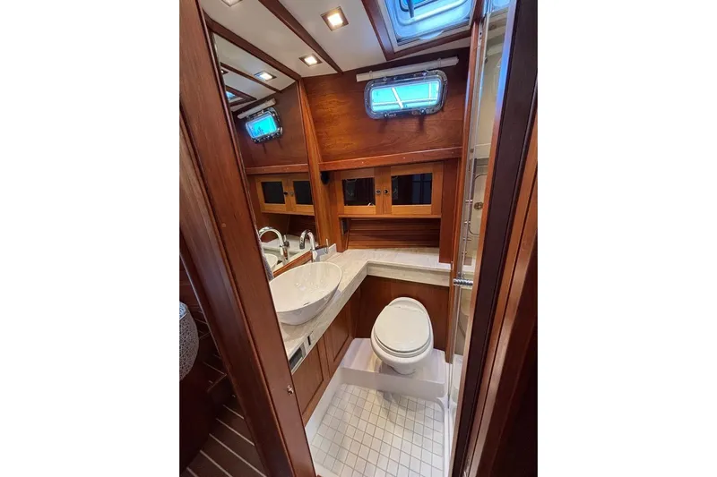 Salish Sky Yacht Photos Pics Luxurious bathroom in 2015 Sabre 54 Salon Express yacht with wood accents and modern fixtures.