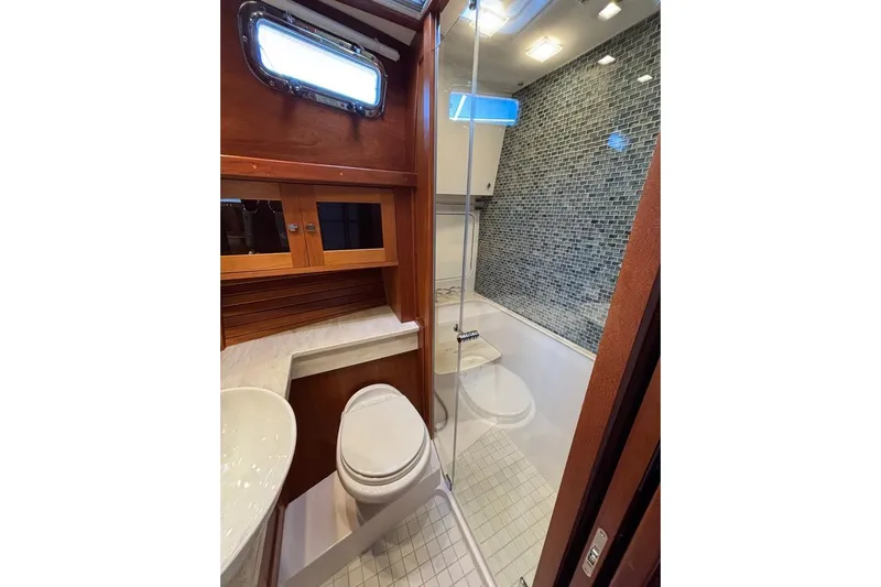 Salish Sky Yacht Photos Pics Luxurious bathroom in 2015 Sabre 54 Salon Express yacht with modern fixtures and wood accents.