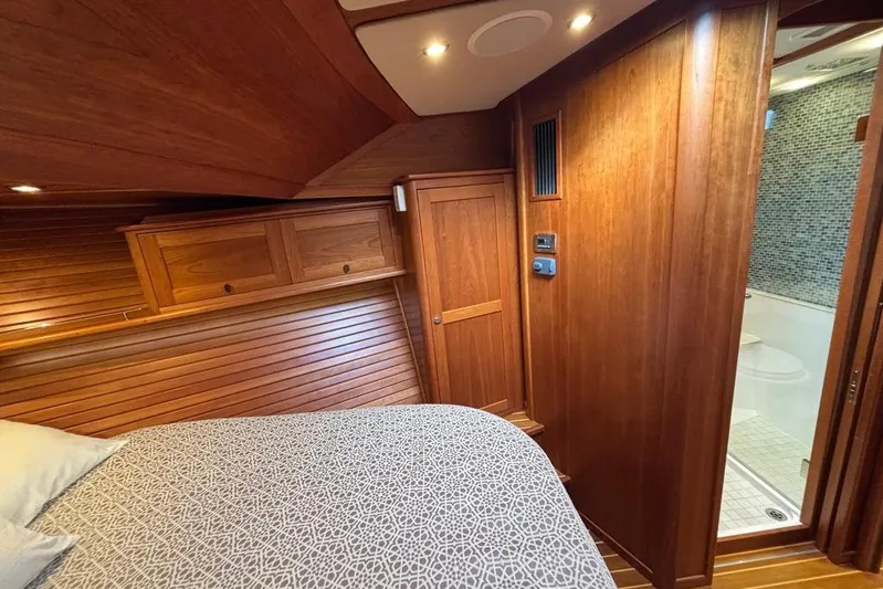 Salish Sky Yacht Photos Pics Luxurious 2015 Sabre 54 Salon Express cabin with wooden interior and ensuite bathroom.