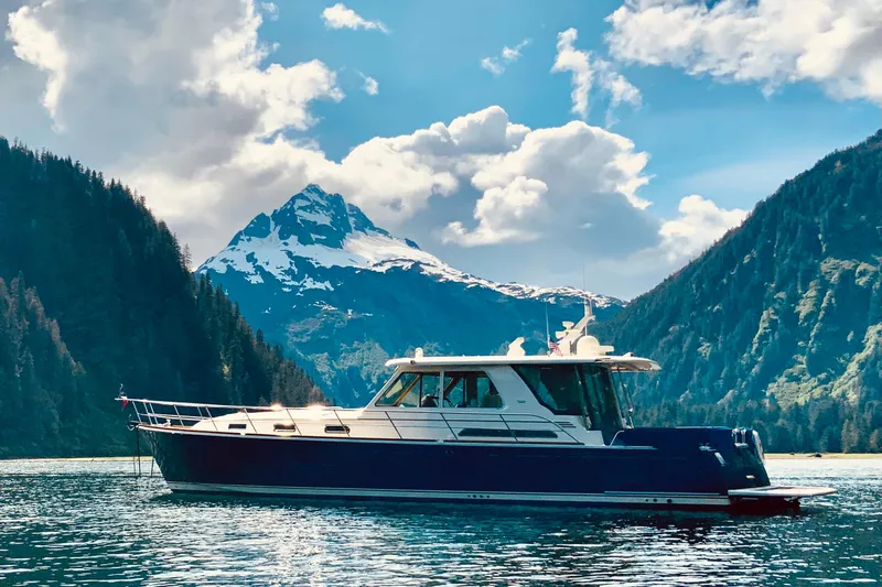Salish Sky Yacht Photos Pics 2015 Sabre 54 Salon Express yacht cruising in scenic mountain lake.