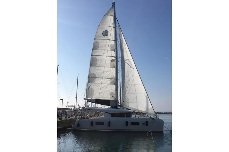 Mojito Yacht Photos Pics 2020 Lagoon 42 sailboat docked with sails raised under clear blue sky.
