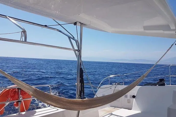 Mojito Yacht Photos Pics Hammock on a 2020 Lagoon 42 yacht, sailing on a clear blue sea.