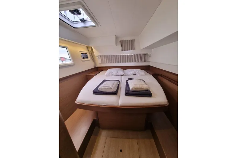 Mojito Yacht Photos Pics Luxurious cabin interior of 2020 Lagoon 42 yacht with cozy bedding.