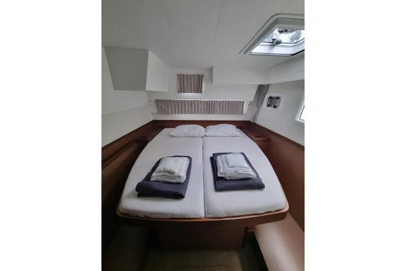 Mojito Yacht Photos Pics Cozy cabin interior of 2020 Lagoon 42 yacht with neatly arranged bedding.