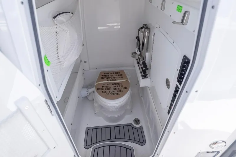  Yacht Photos Pics 2026 Sea Hunt Gamefish 27 Forward Seating boat interior with compact marine toilet.