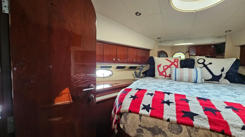 Dream Team Xiii Yacht Photos Pics Luxurious 2005 Neptunus 56 Flybridge yacht bedroom with nautical-themed decor.