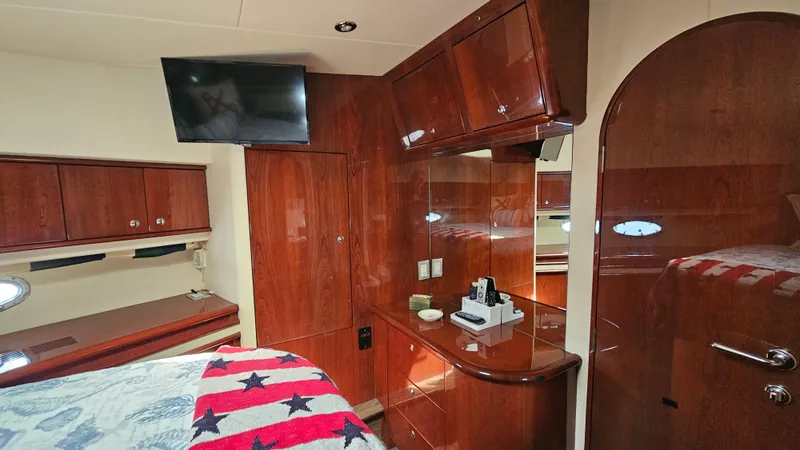 Dream Team Xiii Yacht Photos Pics Luxurious 2005 Neptunus 56 Flybridge yacht interior with wood cabinetry and modern amenities.