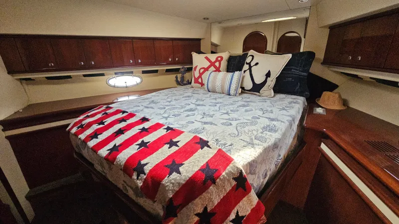 Dream Team Xiii Yacht Photos Pics Luxurious bedroom in 2005 Neptunus 56 Flybridge yacht with nautical decor.