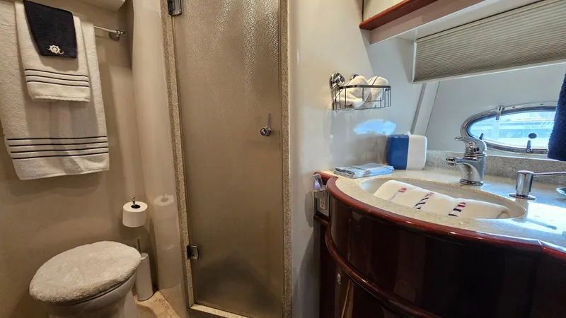 Dream Team Xiii Yacht Photos Pics Luxurious bathroom in 2005 Neptunus 56 Flybridge yacht with shower and vanity.