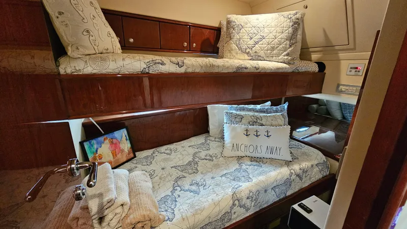 Dream Team Xiii Yacht Photos Pics Cozy cabin interior of 2005 Neptunus 56 Flybridge with nautical-themed bedding.