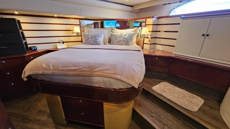 Dream Team Xiii Yacht Photos Pics Luxurious bedroom interior of 2005 Neptunus 56 Flybridge yacht with elegant wood finishes.