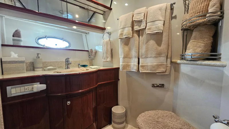 Dream Team Xiii Yacht Photos Pics Luxurious bathroom in 2005 Neptunus 56 Flybridge yacht with elegant wood cabinetry.