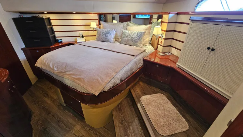 Dream Team Xiii Yacht Photos Pics Luxurious bedroom in 2005 Neptunus 56 Flybridge yacht with elegant wood accents.